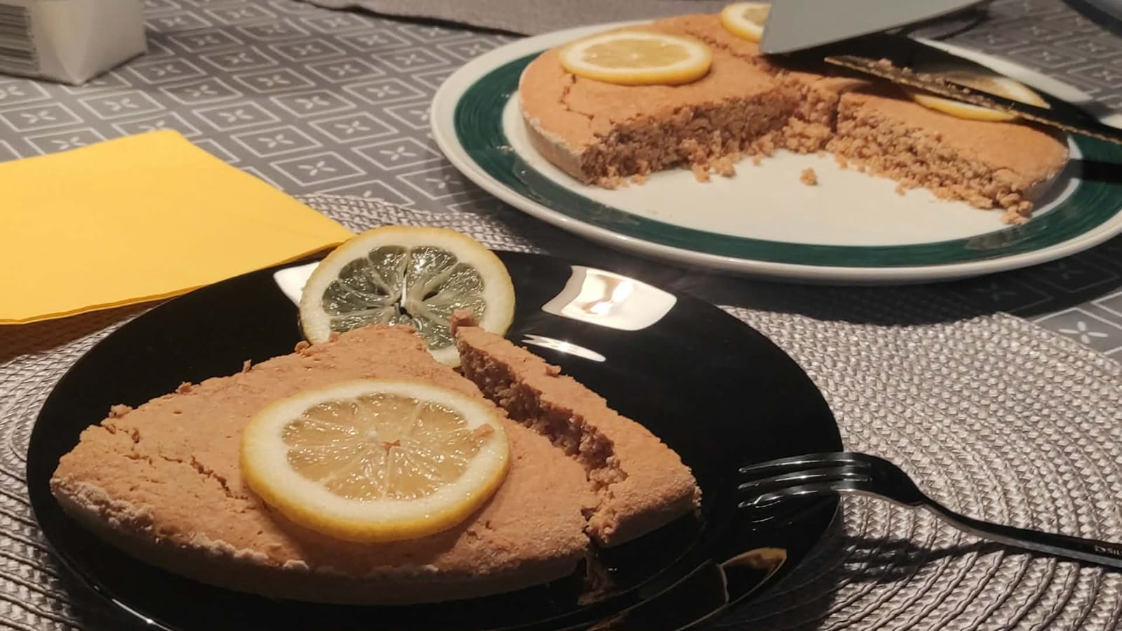 A lemon cake, perfectly served on the table, as if in a restaurant